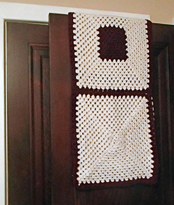 Knit prayer shawl over door