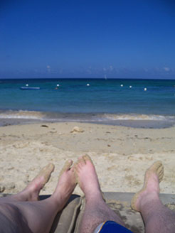 Dan and Wife Heather's feet on a beach in Jamaica