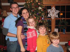 five children posed in height order from tallest to shortest.