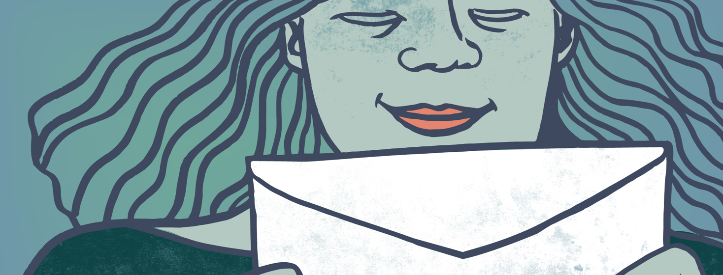 A person with wavy hair smiles as she holds an envelope in front of her.