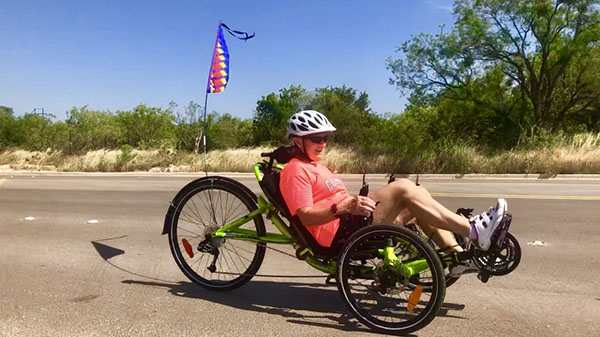 Advocate on low riding trike on the street on a sunny day